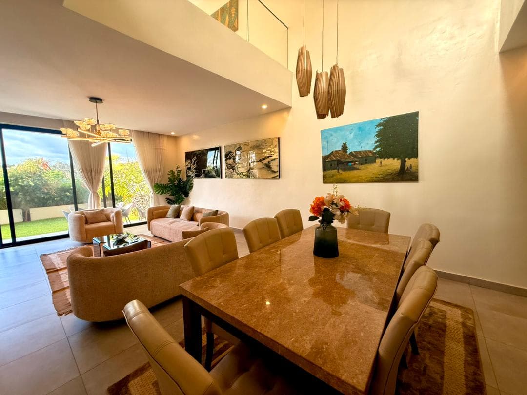 Marble dining table with pendant lights and garden view