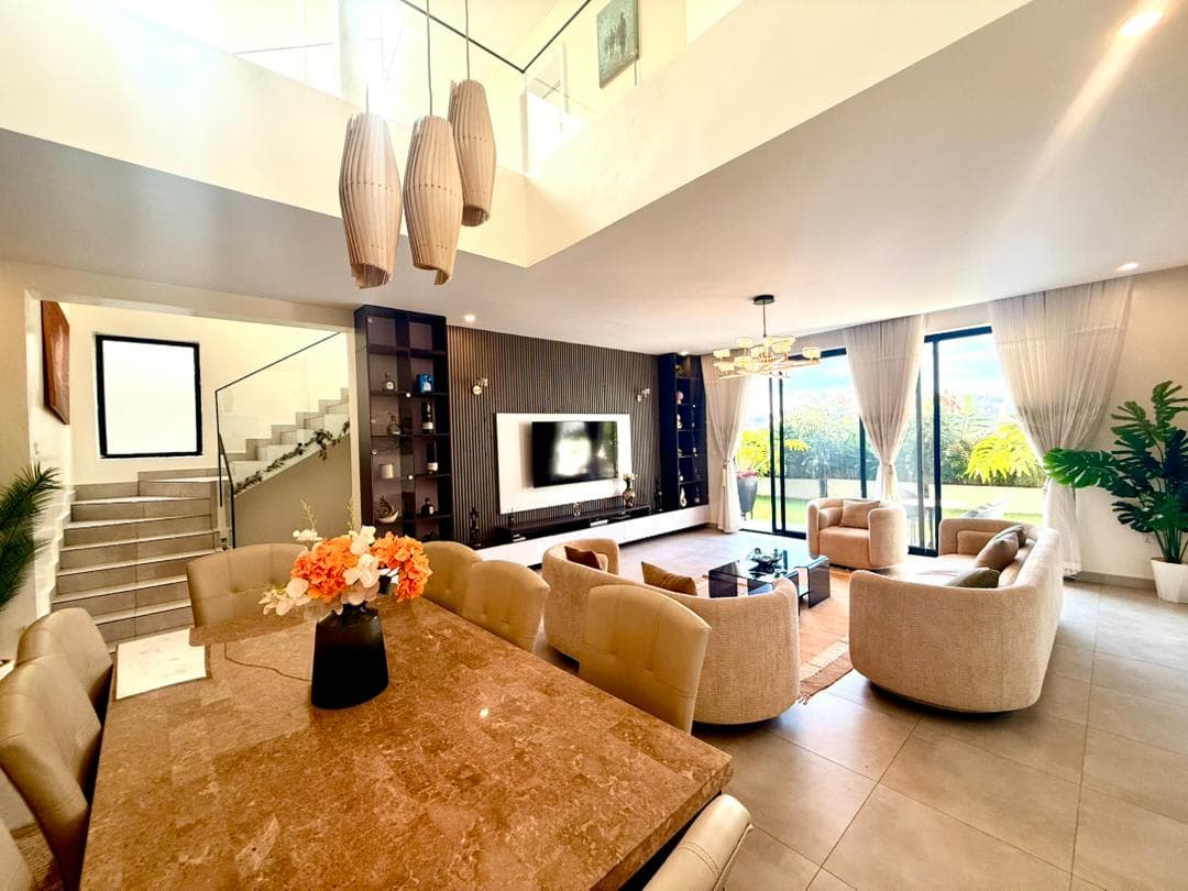 Double-height open-plan living and dining with staircase