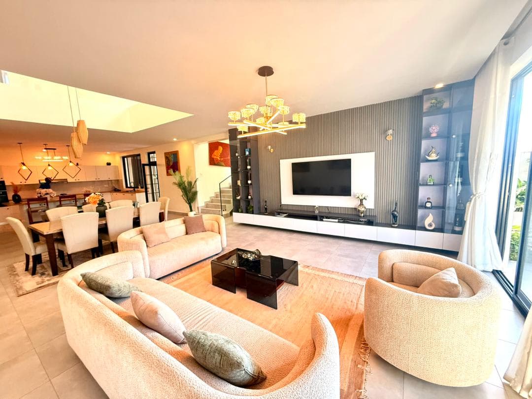 Open-plan living room with gold chandelier and kitchen